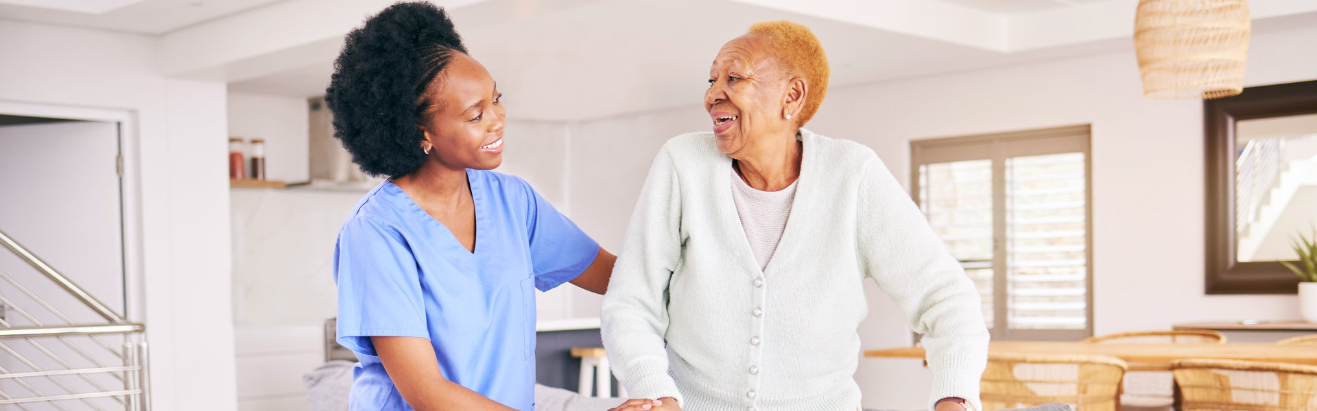 caregiver assist her patient in standing